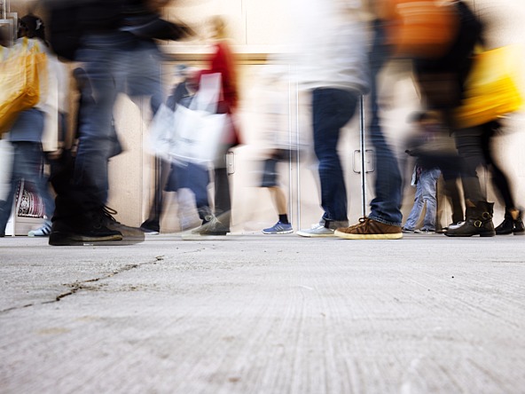 Conceptual image of shopping, with blurred people, moving quickly to represent the FMCG sector